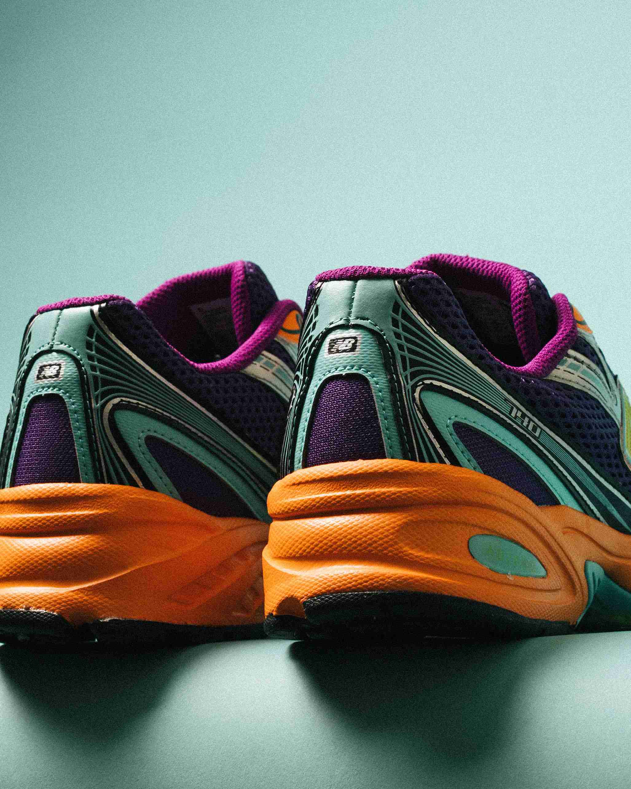 Paire de sneakers multicolores posée sur un fond clair, vue de trois quarts mettant en avant les formes et détails du modèle.